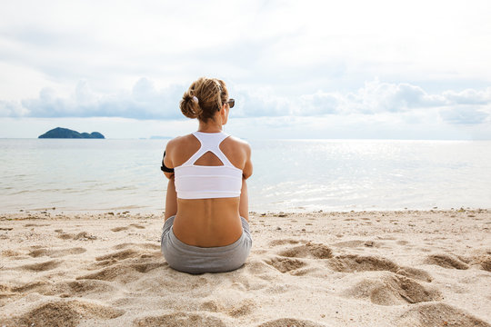 Woman Resting after Jogging at the Beach