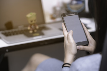 Young woman is relaxing by using smartphon