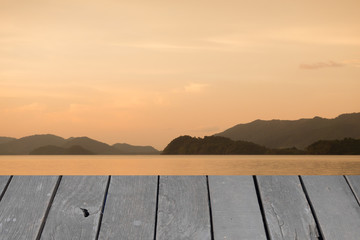 Naklejka na ściany i meble wooden with beautiful sunset at sea
