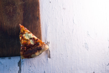 Home pizza on a textured wooden background.