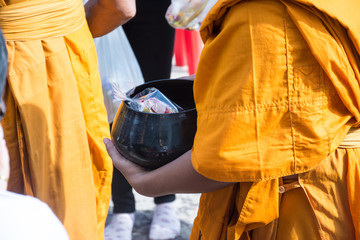  Buddhist monks are given food offering from people for End of Buddhist Lent Day
