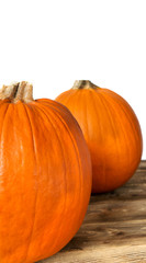Orange pumpkins on a wooden table and white background