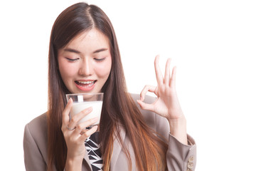 Healthy Asian woman drinking a glass of milk show OK sign.