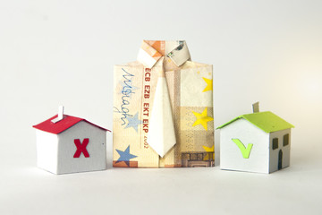Shirt made with a banknote and two paper houses that represents a mortgage or a loan accepted or refused