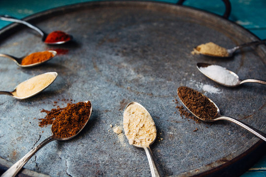 Spoons with spices arranged in a radial pattern