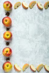 Recipe background with whole apples, apple wedges and star anise