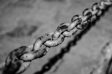 Large old chain of rusty metal in the city. Urban.