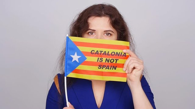 Serious catalan woman with estelada flag. Referendum For The Separation Of Catalonia From Spain