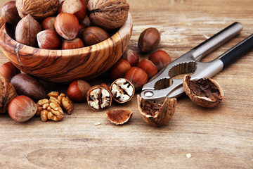 Large diversity of healthy nuts in wooden bowl.
