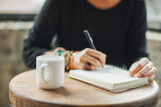 Woman Writing in Her Notebook