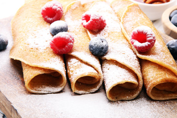 Delicious Tasty Homemade crepes or pancakes with raspberries and blueberries