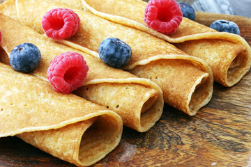 Delicious Tasty Homemade crepes or pancakes with raspberries and blueberries