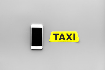 Choose a taxi in mobile application. Grey background top view copyspace