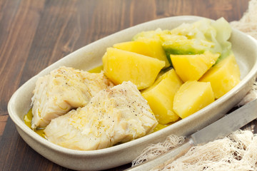 boiled cod fish with potato on dish