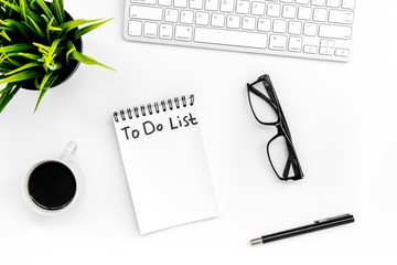 To do list for businessman in notebook on office table. White background top view