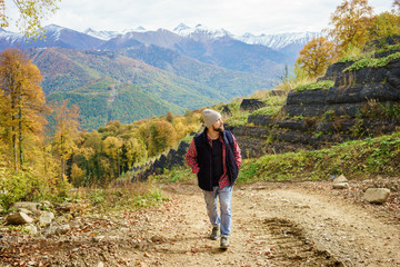 hiker standing in front of a majestic mountain landscape