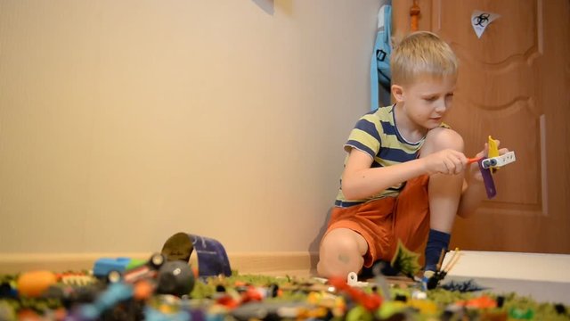 A boy of 8 years playing toys in an ordinary home environment