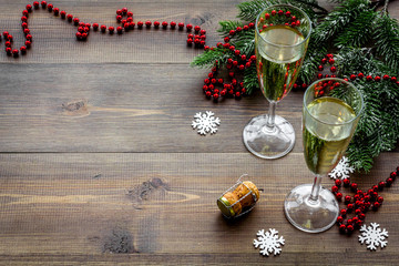 Obraz na płótnie Canvas Glasses of champagne in eve of New Year 2018 near spruce branch on wooden background copyspace