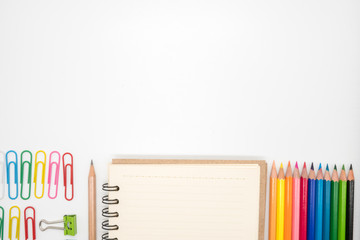 Stationery included paper clips,pencil,notebook and color pencils on white background with copy space