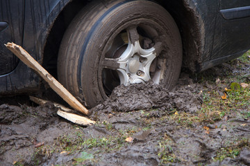 Fototapeta na wymiar car wheel stuck in the wet mud