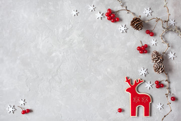 Christmas background with branches, cones, red berries and reindeer