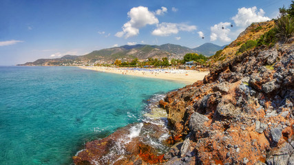 Mountains and seascape on sunny summer day in Alanya, Turkey. Beautiful view on tropical beach and coastline through Turkish rocks.