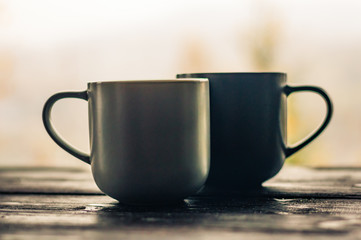 Still life with cup of coffee on the carpathian mountains background during the sunset