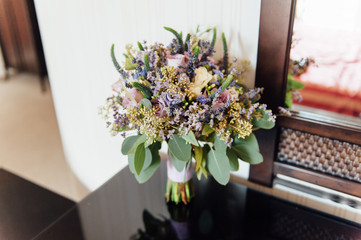Beautiful wedding bouquet lie on glass table