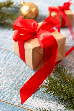 Christmas decorations - gift box with red ribbon. Vertical image.
