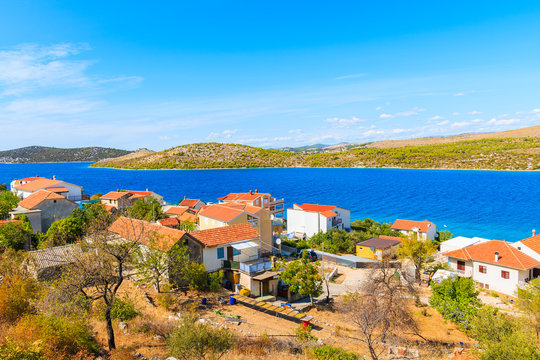 View of houses with orange tile roofs and sea bay near Zaboric town, Dalmatia, Croatia