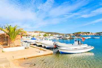 Fototapeta na wymiar Fishing boats on beach with shallow crystal clear sea water in Rogoznica town, Dalmatia, Croatia