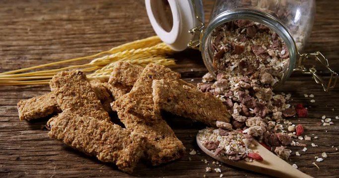 Granola bars and breakfast cereals spilling out of bottle 