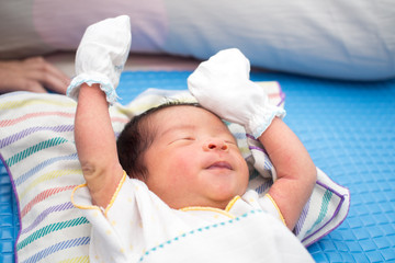 Close Up of Asian Baby Sleeping with Hands Up