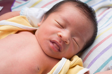 Close Up of Asian Baby Sleeping with Tongue Stick out