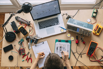 Engineer Testing Electronic Equipment at Home