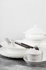 Clean white tableware on a gray background