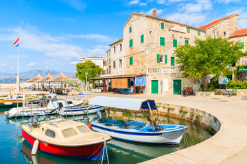 Fototapeta na wymiar Fishing boats in Postira village with beautiful port, Brac island, Croatia