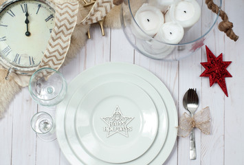 Christmas table setting in silver tone on wooden table