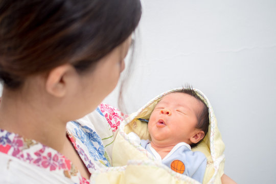 Whistling Baby Carried By Mom