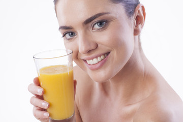 Smiling woman with orange juice.