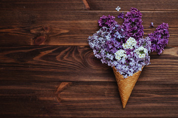 Ice cream waffle cones with lilac flowers
