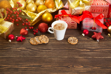 Obraz na płótnie Canvas Christmas card. Christmas gift, cup of coffee and decorations on wood background. Christmas lifestyle concept. .