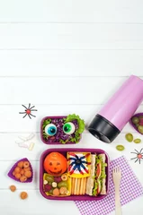 Fotobehang Open Halloween lunch box with school lunch near thermo mug on white background © lithiumphoto
