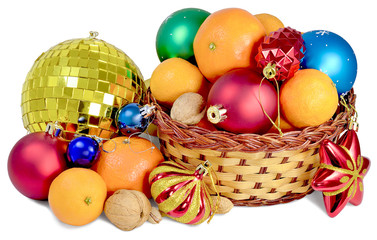 Christmas gift basket with festive decorations glass toys of different shapes red blue green and orange fruit mandarins nuts, walnuts