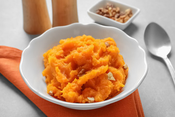 Bowl with mashed sweet potato on table
