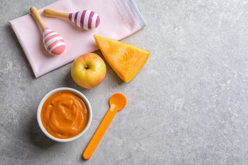 Composition with baby food and products on grey background