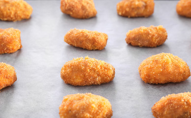 Delicious salmon croquettes on parchment, closeup