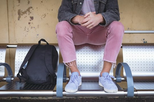 Low section of man sitting on bench