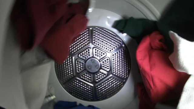 Slow Motion Clothes Tumbling In Laundry Dryer.  