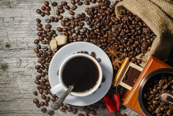 Coffee cup with coffee bag on wooden table. View from top.